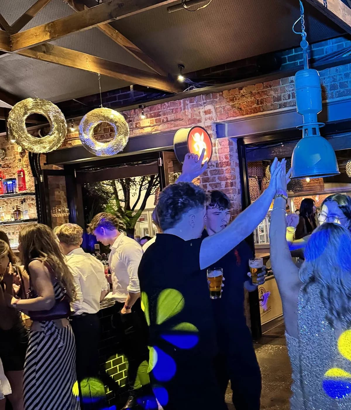 Packed Adelaide party dance floor lit in blue and yellow by Shakin Entertainment